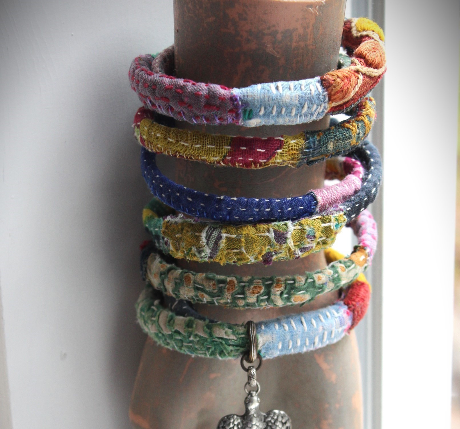 Infinite Possibilities Coiled Kantha & Embroidered Lambani Textile Bracelet with Dove of Peace Medal and Silk Tassel